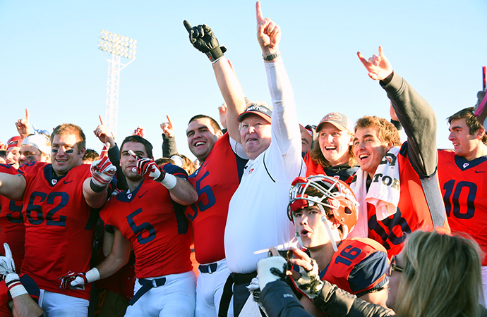 Dayton head coach Rick Chamberlin celebrates with his team following Saturday's victory. (Photo by Eric Schelkun)